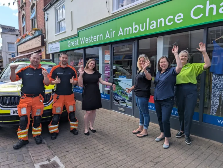 People standing outside an air ambulance charity shop