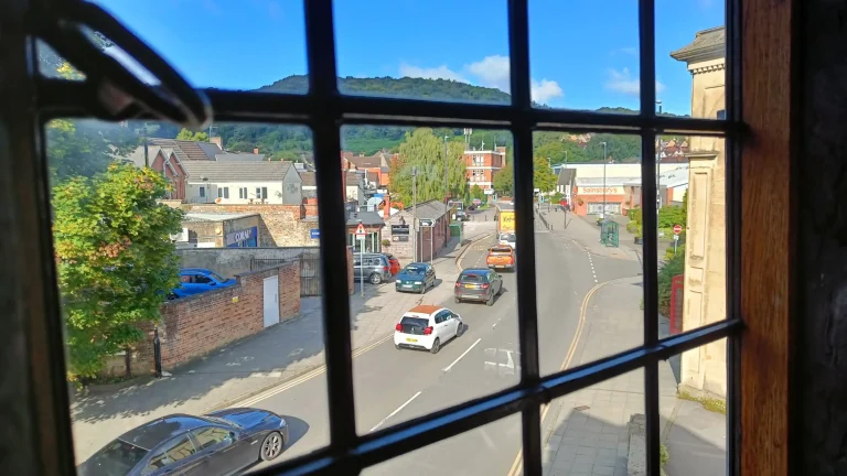 Looking through a lead light window onto a street of traffic