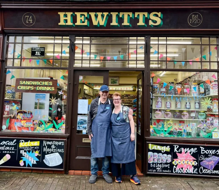 Man and woman standing outside a shop called Hewitts