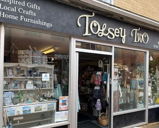 A shop called Tolsey Two with a person walking out the door