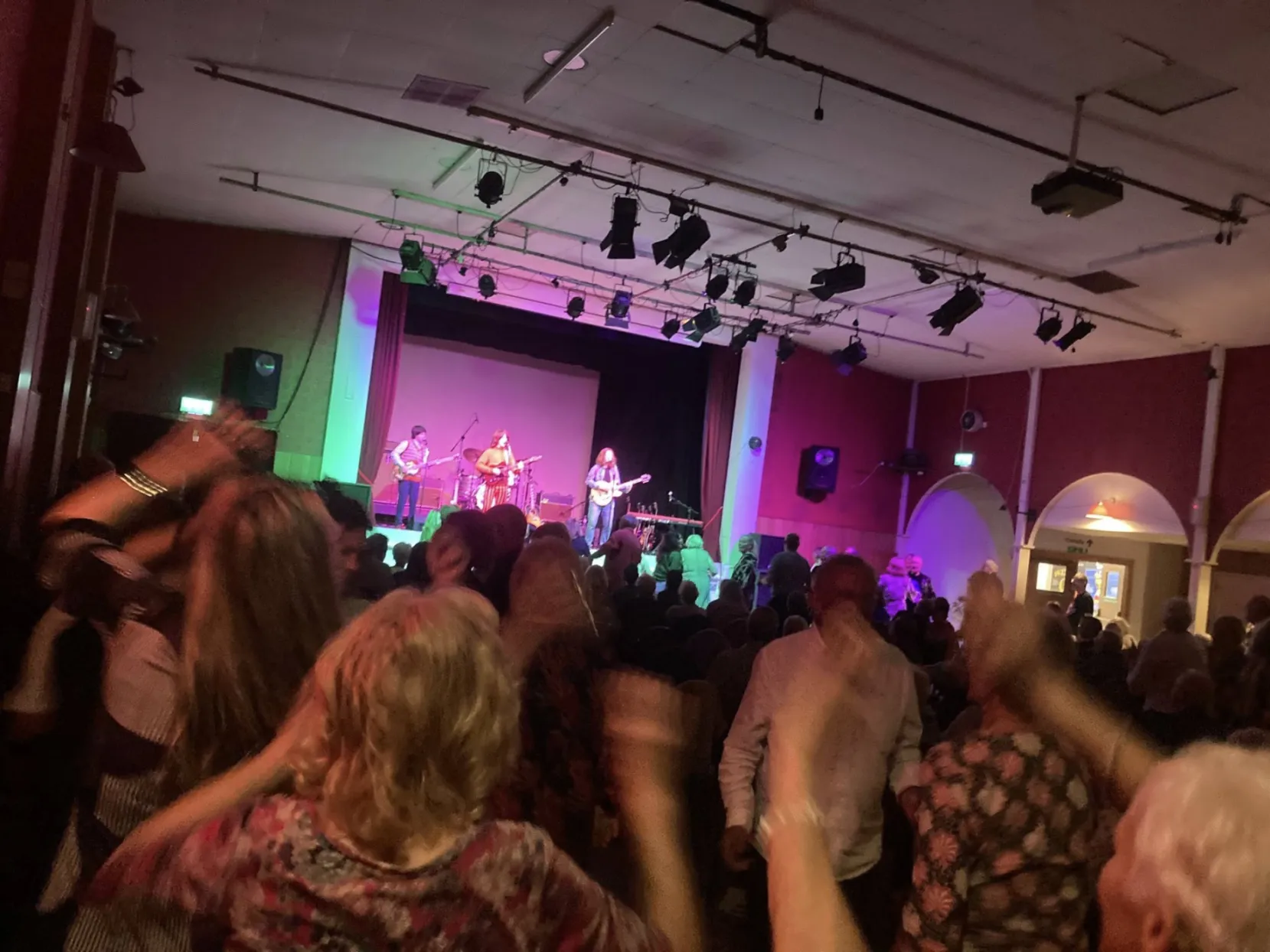 People watching a band on a stage