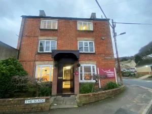 Three storey red brick building with six windows at the front. Office of Red Kite solicitors