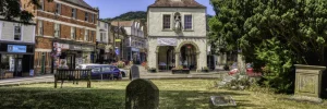 Looking at the Market house in Dursley green lawn in foreground and parsonage street in the background